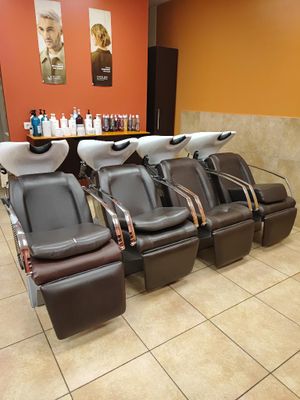 a row of chairs in a salon waiting for people to get their hair done