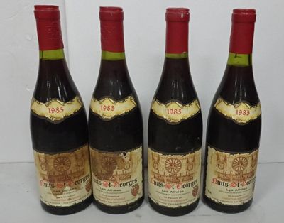 four bottles of wine are lined up on a table