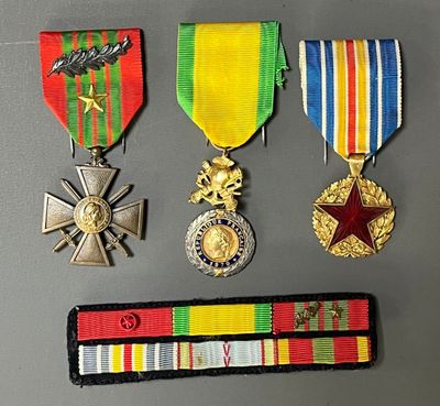 four medals and a ribbon on a table