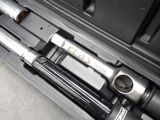 two wrenches in a tool case on the floor