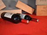 two bottles of wine sitting next to each other on a table