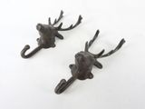 two metal hooks with a deer head on them