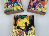 three comics are stacked on top of each other on a table