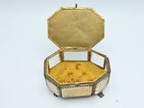 a gold and silver box that is open on a white surface