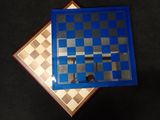 two pieces of blue and white chess board on a black surface