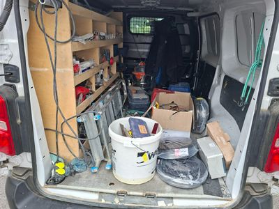 the back of a van with a bunch of items in the back