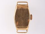 an image of a gold watch on a white surface with a white background