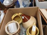 many cups and saucers in a box on the floor