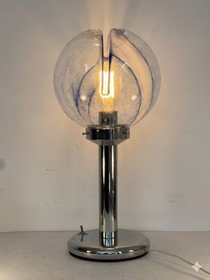 a lamp that is on a table with a light on it