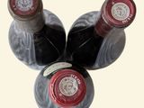 three bottles of wine sitting next to each other on a table