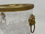 a glass jar with a gold lid on a white surface