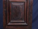 an old wooden cabinet with a door on top of it