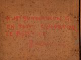 an old book with writing on it sitting on a table