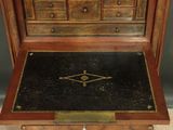 a wooden desk with a drawer on top of it