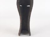 a wooden sculpture of a head on a white surface