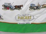 a green and white table cloth with a picture of a horse drawn carriage