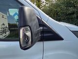 a white van that is parked on the side of the road