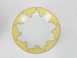 a yellow and white plate on a white table
