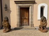 two statues of lions in front of a building