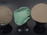 three hats are lined up on top of each other on a black surface