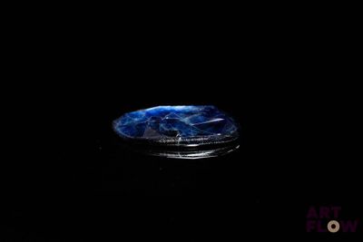 an image of a coin in the dark with a black background