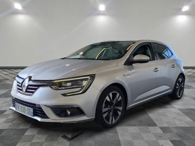 a silver car parked in a room with a checkered floor
