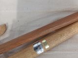 two wooden baseball bats laying on a white cloth