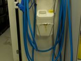 a blue hose attached to the side of a machine