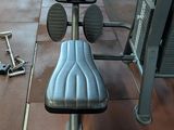 an image of a gym room with a bench and weights