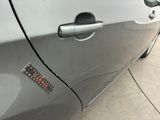 a close up of a car door handle with a sticker on it