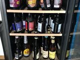 many bottles of beer on the shelves in the refrigerator