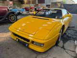 a yellow car that is parked in a parking lot