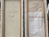 two framed pictures with writing on them on display