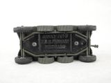 a toy army vehicle with wheels on a white surface