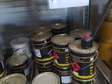 many cans of paint on a pallet in a warehouse