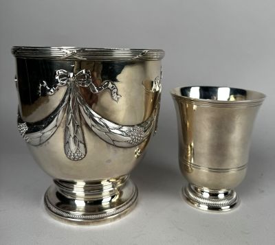 silver plated cup and a silver plated cup on a white surface