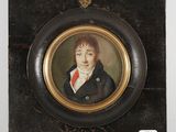 portrait of a young man in a black coat and red tie