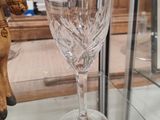 a glass with a horse on it and a wine glass with a horse on it