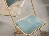 a blue and gold folding chair sitting in a room