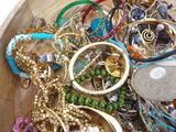 a wooden bowl filled with lots of different colored bracelets
