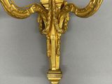 an image of a gold plated wall sconce with two candles