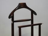 a coat rack with a wooden hanger on top of it