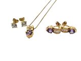 a close up of a necklace and earring set with purple stones