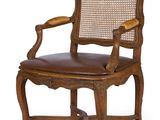 une image représentant une chaise en bois avec une assise en cuir marron