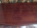 a wooden table with a clock on top of it