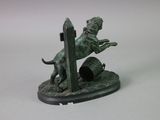bronze statue of a man on a horse jumping over a barrel