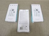 three boxes of silverware sitting on top of a table next to a knife, fork and spoon