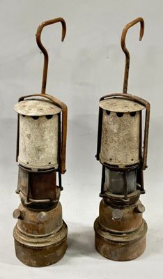 two old fashioned lamps that are sitting on a table