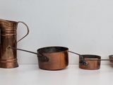 a lot of copper items on a white surface