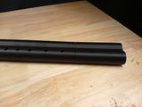 a close up of a flute sitting on top of a wooden table
